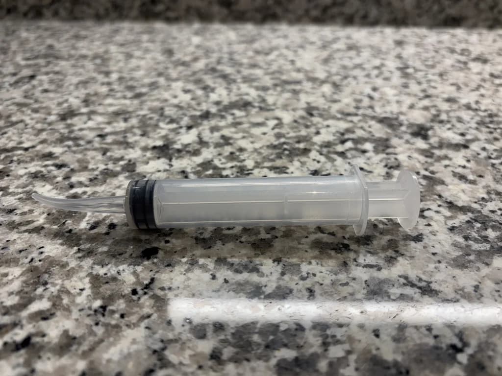 Monoject curved-tip syringe for tonsil stone removal at home